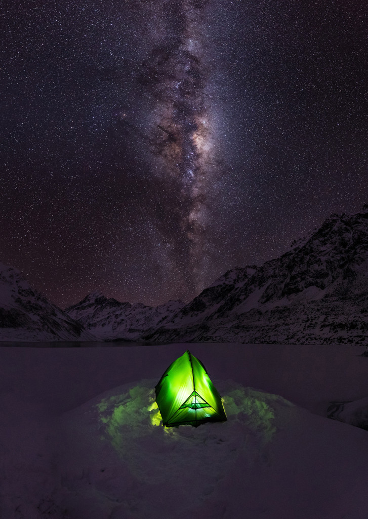 "After a large winter storm blanketed the South Island of New Zealand with snow, many of the high country roads in Central Otago were impassable.  I was stuck in Mount Cook Village for a few days, so I hiked into the Hooker Valley and made camp on a frozen iceberg in the middle of Hooker Lake. I spent the night here and took photos of the Milky Way arching over my tent, Mount Cook, and the surrounding Southern Alps on one of the coldest and clearest nights of my life. Mount Cook is New Zealand's tallest mountain. "